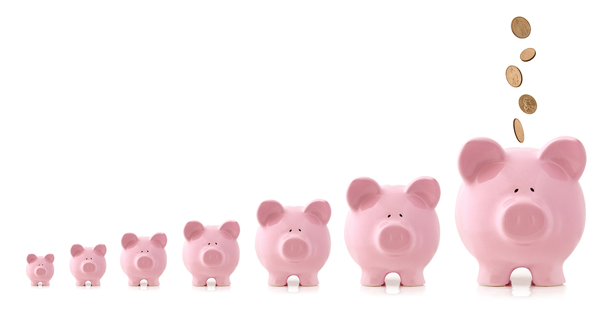 pink piggy banks increasing in size, with coins falling into lar